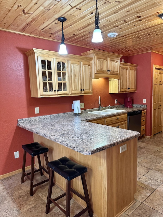 kitchen featuring wood ceiling, a breakfast bar, a peninsula, stainless steel dishwasher, and a sink