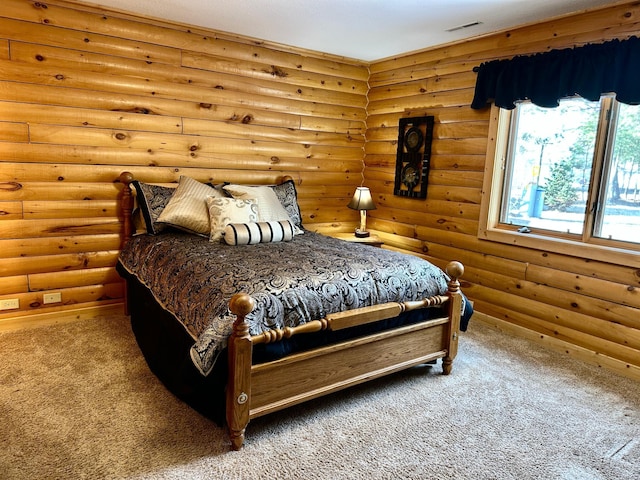 carpeted bedroom featuring rustic walls and visible vents