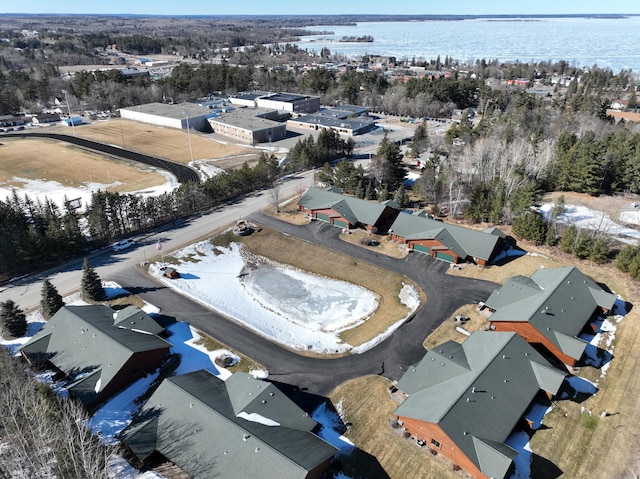 drone / aerial view featuring a residential view and a water view