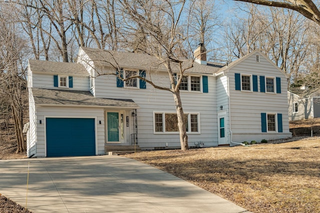 traditional-style home with a garage, driveway, roof with shingles, and a chimney