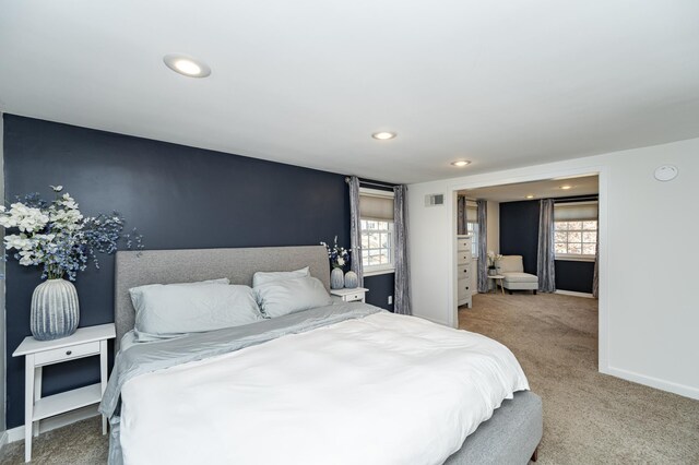 carpeted bedroom with recessed lighting, visible vents, and baseboards