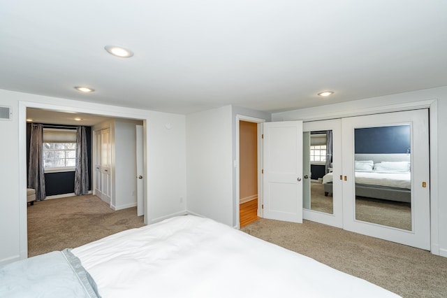 carpeted bedroom with recessed lighting, visible vents, baseboards, and french doors