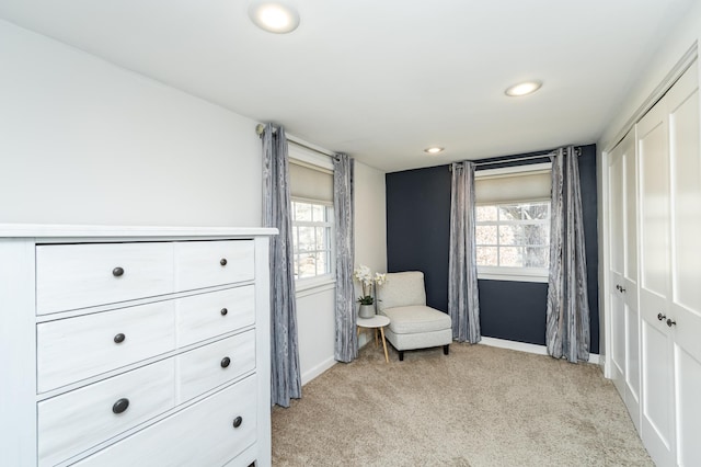 living area featuring light carpet, recessed lighting, a healthy amount of sunlight, and baseboards