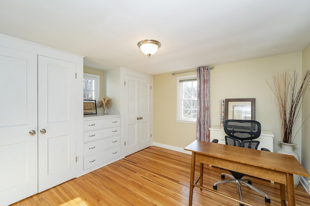 office area featuring baseboards and light wood-style flooring