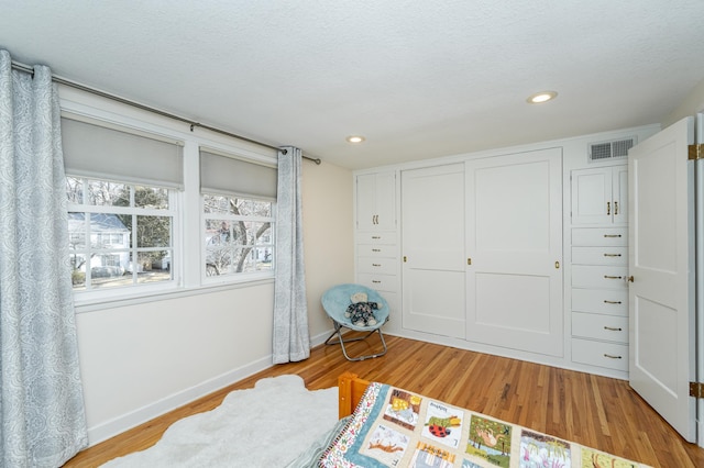 bedroom featuring recessed lighting, light wood-style floors, a closet, and baseboards