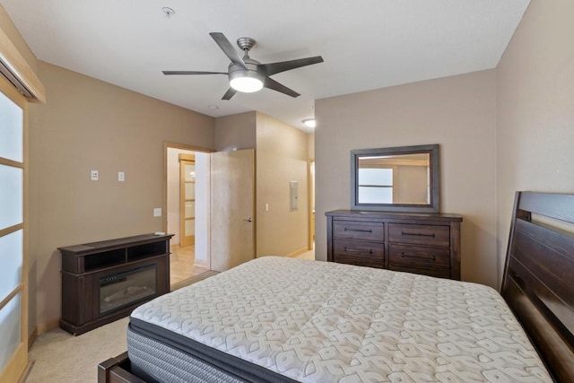 bedroom featuring baseboards, light carpet, and a ceiling fan