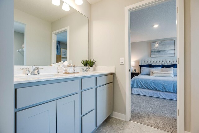 12376 81st St NE, Otsego, MN 55330 - full bath featuring connected bathroom, double vanity, baseboards, and tile patterned flooring