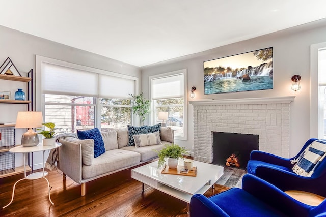 living room with wood finished floors and a fireplace