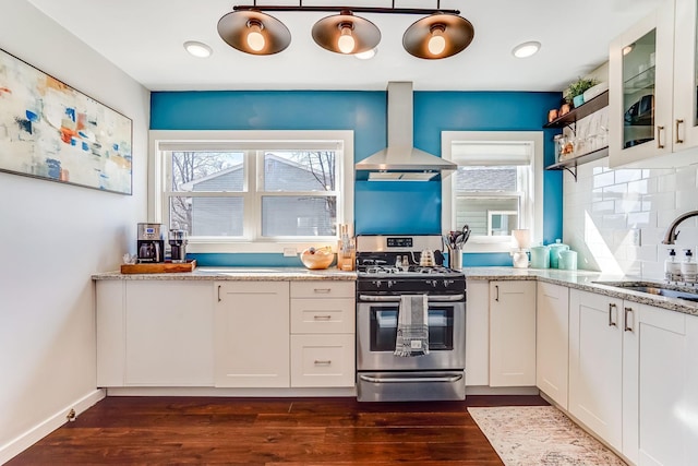 kitchen featuring plenty of natural light, gas range, ventilation hood, and a sink