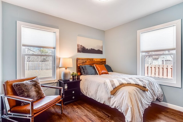 bedroom featuring baseboards and wood finished floors