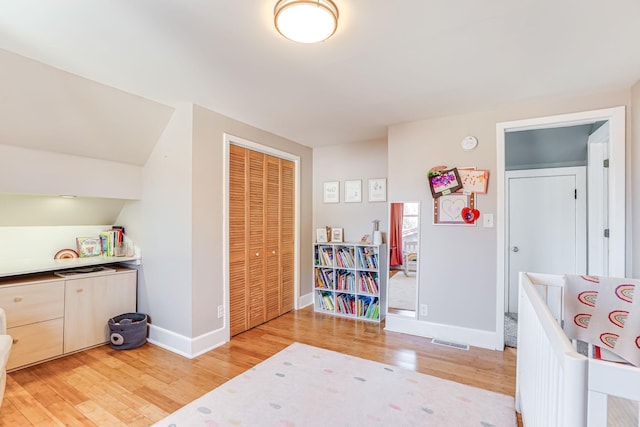 game room featuring visible vents, baseboards, and wood finished floors