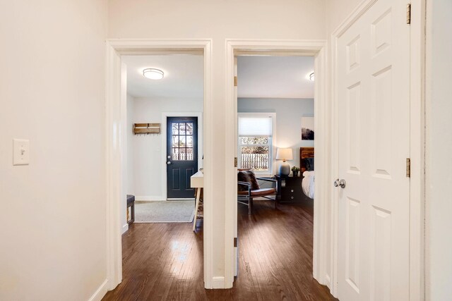 hall featuring dark wood finished floors and baseboards