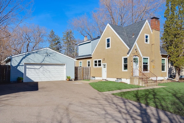 view of front of property with an outbuilding, a chimney, a front lawn, and fence