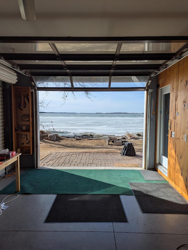 garage featuring wooden walls and a water view