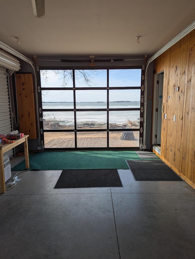 garage featuring a water view and wood walls