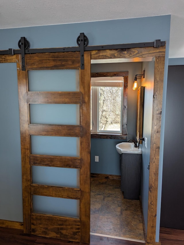 bathroom with vanity and baseboards