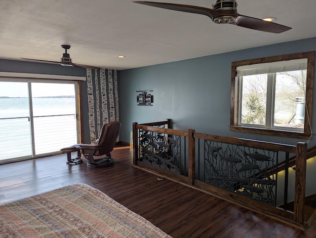 bedroom with ceiling fan, wood finished floors, and access to exterior