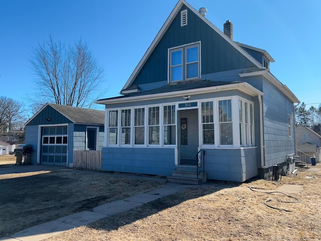 211 Hartley St, Coleraine, MN 55722 - view of front of house featuring a chimney and a detached garage