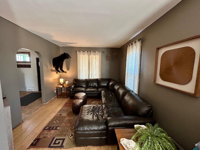 211 Hartley St, Coleraine, MN 55722 - living area with arched walkways, visible vents, and wood-type flooring