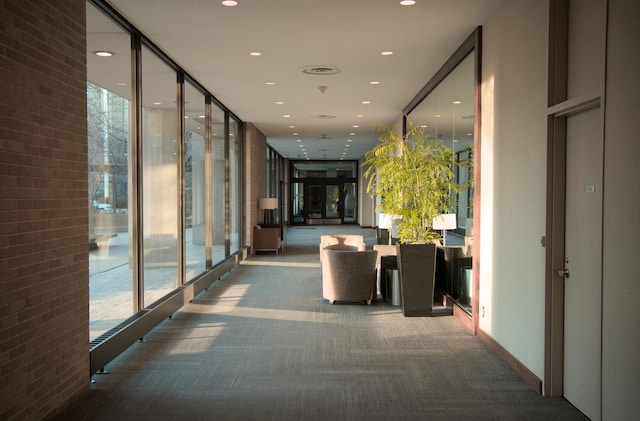 corridor with recessed lighting, carpet flooring, and floor to ceiling windows