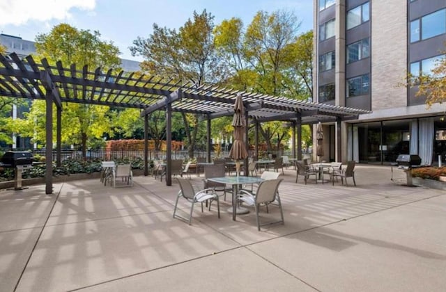 view of patio / terrace with area for grilling, a pergola, and fence