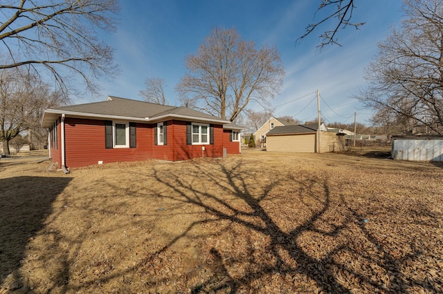 view of side of home with an outbuilding