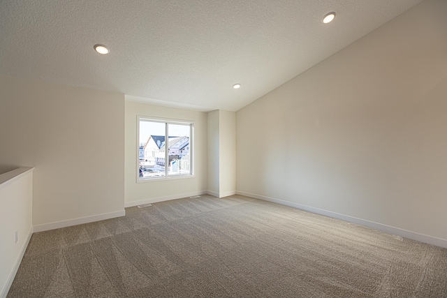 carpeted empty room featuring recessed lighting, baseboards, and a textured ceiling