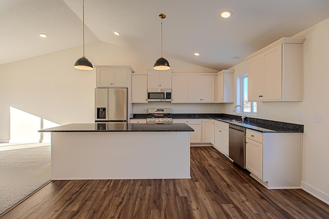 kitchen with a sink, lofted ceiling, white cabinets, stainless steel appliances, and dark wood-style flooring