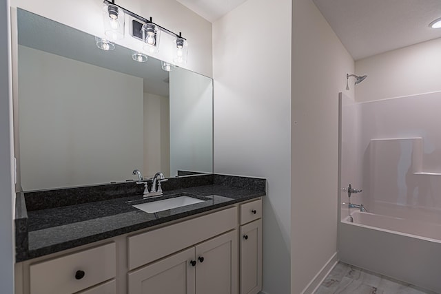 full bath with vanity, marble finish floor, and shower / bathtub combination