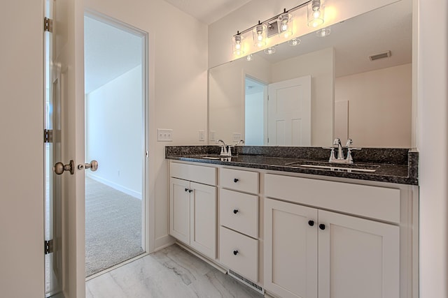 full bathroom featuring double vanity, visible vents, marble finish floor, and a sink