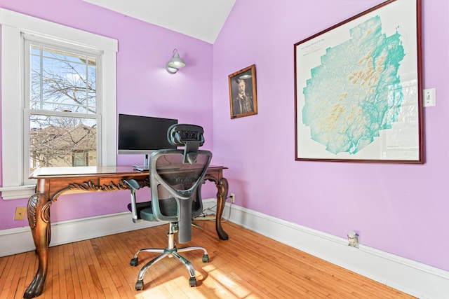 office area with vaulted ceiling, hardwood / wood-style flooring, and baseboards