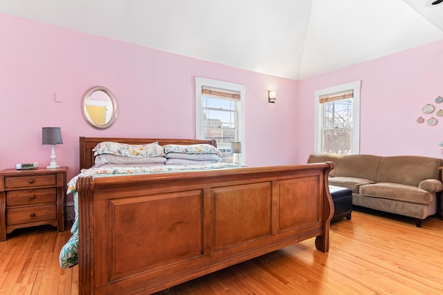 bedroom featuring light wood-style floors and vaulted ceiling