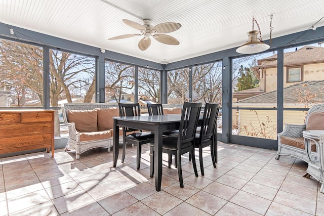 sunroom / solarium featuring plenty of natural light and ceiling fan