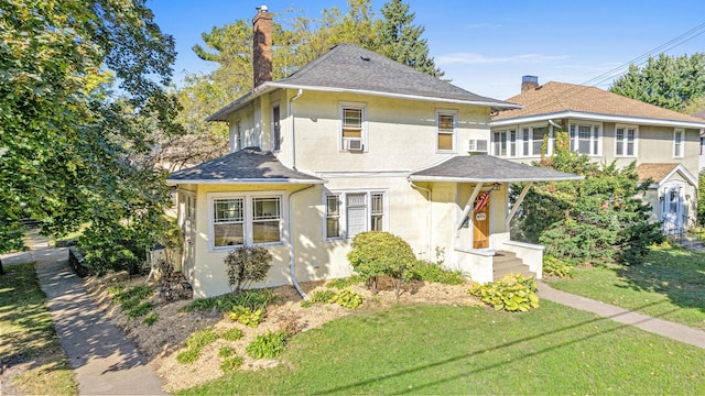 view of front of property featuring a front lawn, a chimney, and stucco siding