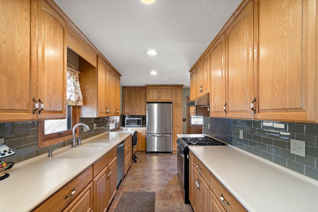 kitchen with tasteful backsplash, brown cabinets, stainless steel appliances, and a sink