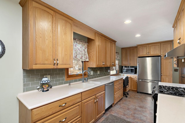 kitchen featuring a sink, tasteful backsplash, appliances with stainless steel finishes, and light countertops