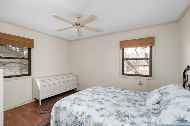 bedroom featuring crown molding, wood finished floors, and ceiling fan