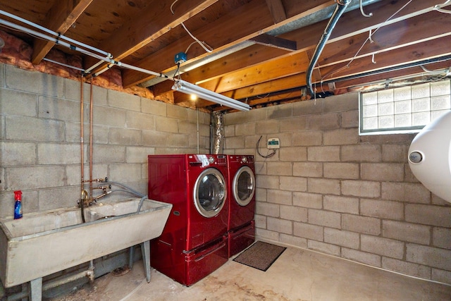 laundry area with a sink, laundry area, and washer and clothes dryer