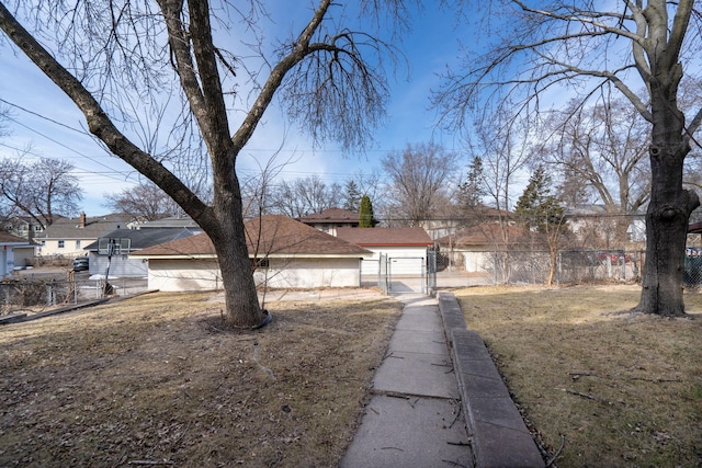 view of front of home with fence, a front yard, and a gate