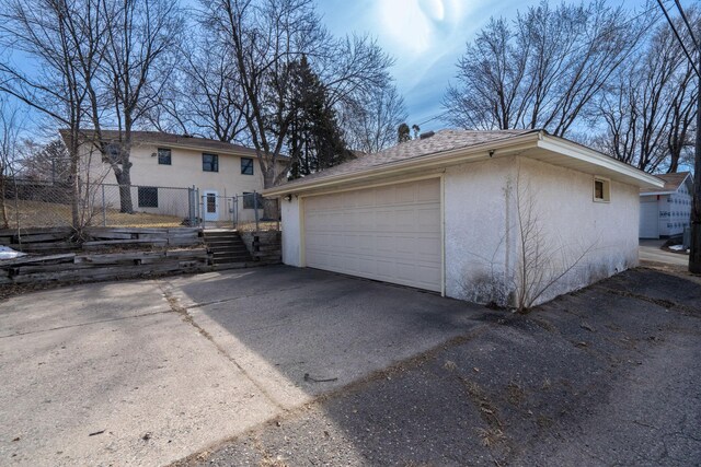 detached garage featuring fence