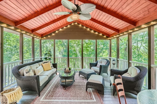 sunroom featuring plenty of natural light, wood ceiling, and a ceiling fan