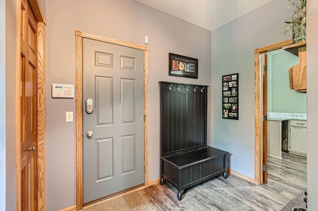 foyer entrance featuring wood finished floors and baseboards