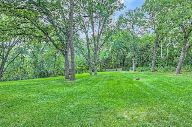 view of yard featuring a forest view