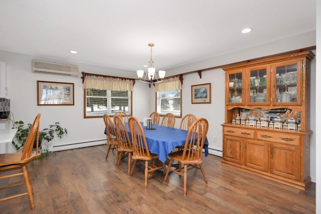 dining area featuring a baseboard radiator, wood finished floors, a chandelier, and a wall mounted AC