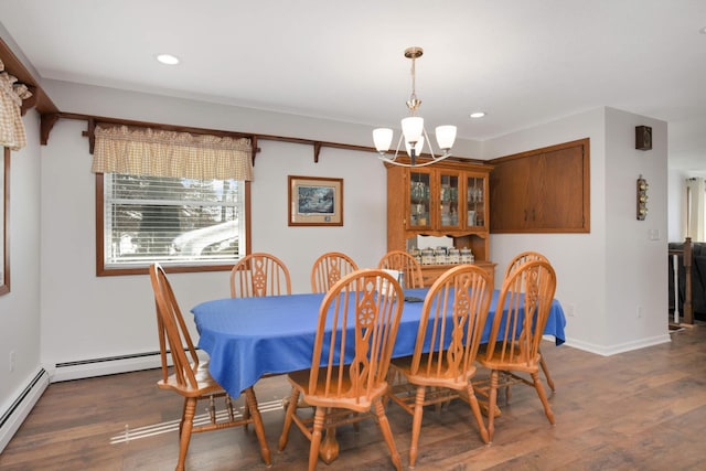 dining room featuring a notable chandelier, recessed lighting, a baseboard heating unit, and wood finished floors