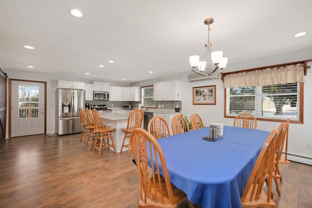 dining room with recessed lighting, a chandelier, and dark wood-style flooring