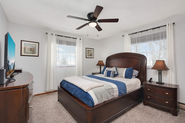 bedroom with light colored carpet, baseboards, and ceiling fan