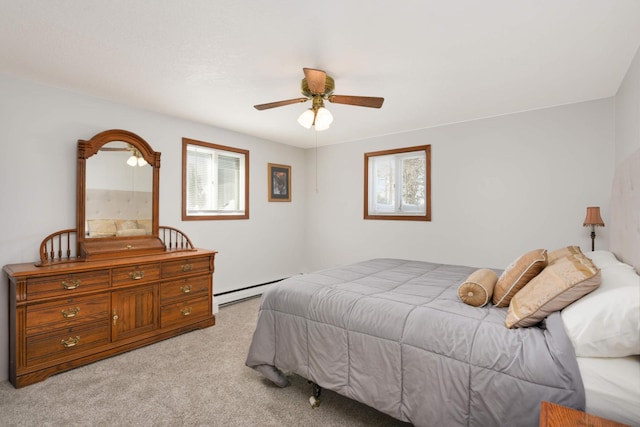 bedroom with light carpet, a ceiling fan, and a baseboard radiator