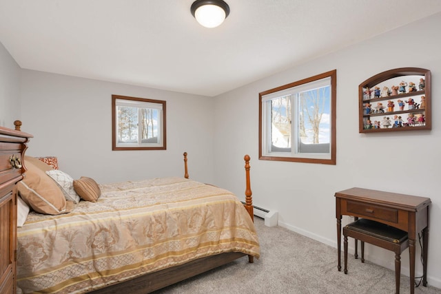 carpeted bedroom with baseboard heating, multiple windows, and baseboards