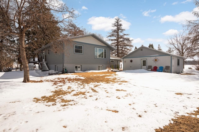 view of snow covered rear of property